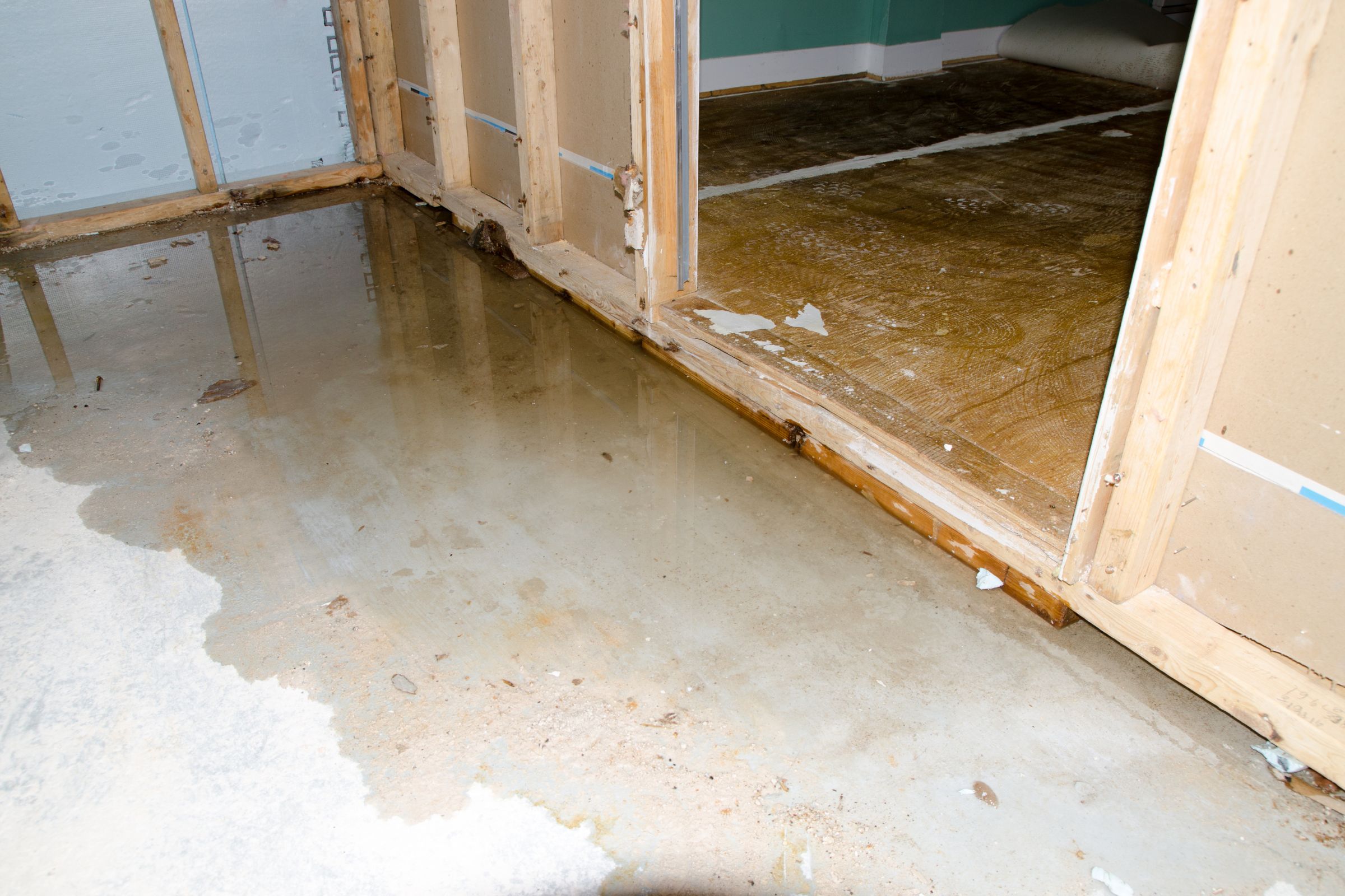 A room showing signs of water damage, featuring a door, highlighting the need for restoration services in Miami, FL.